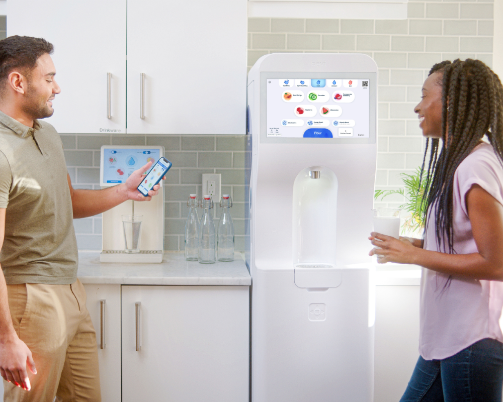 Colleagues talking a breakroom with counter-top and standing Bevi mahchines in the background