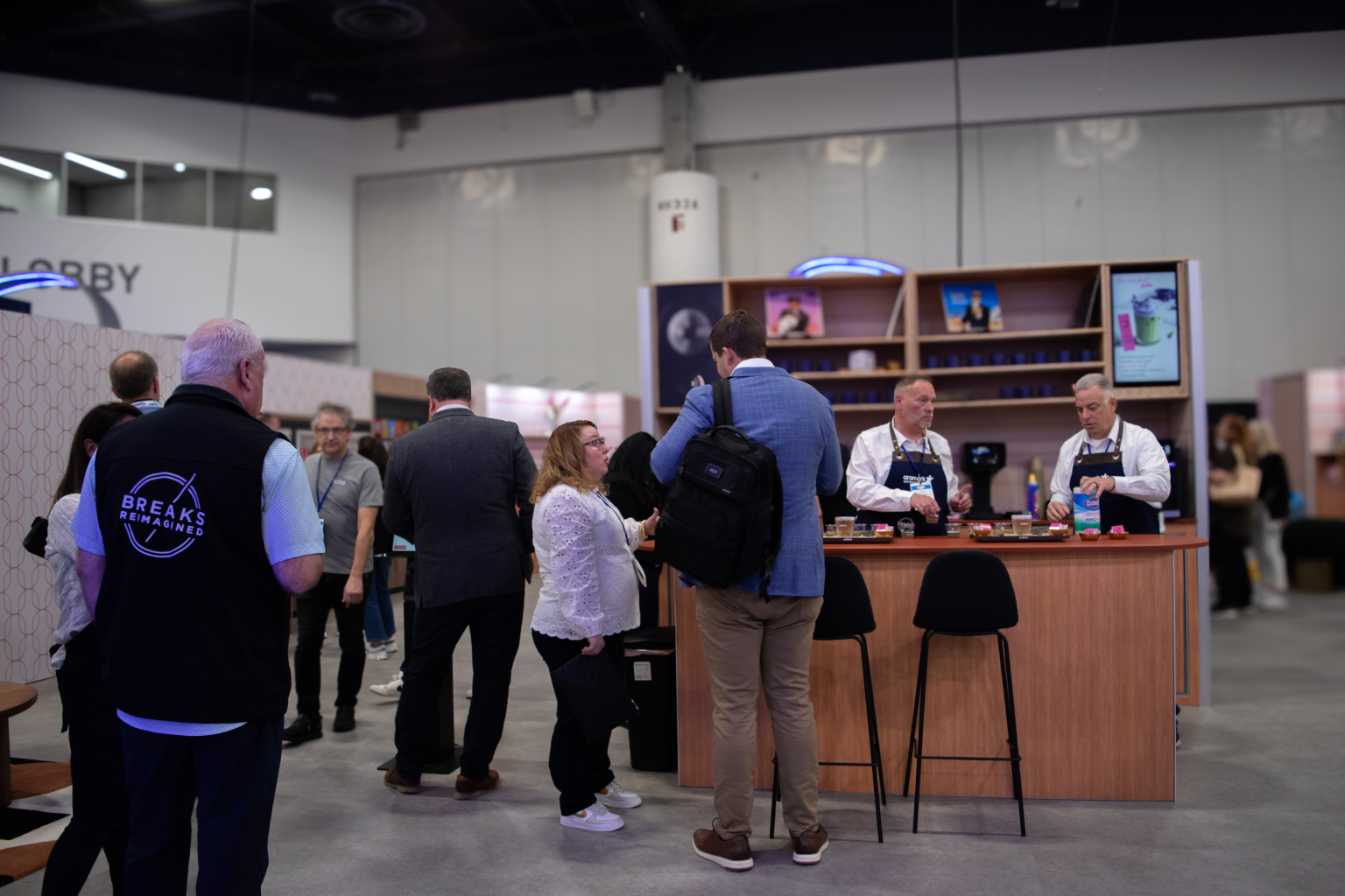 NAMA 2025 attendees surrounding a beverage tasting counter
